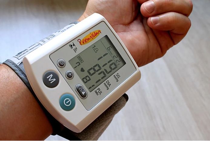 A man checking his blood pressure at home