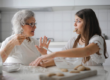 A grandmother and her granddaughter spend time and bond while baking in the kitchen.